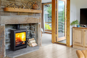 Portway Arundel XL 5kW Wood Burning Stove in a brick fireplace suite