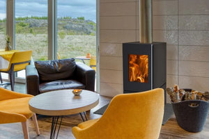 Bronpi - Bombay F - 9kW Freestanding Wood Stove wuth flames in an office dining area